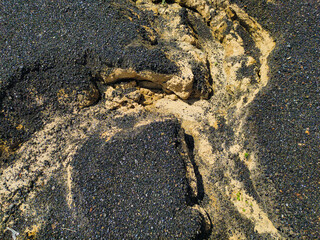 Close up photo of cracked ground with a ditch caused by continued rain