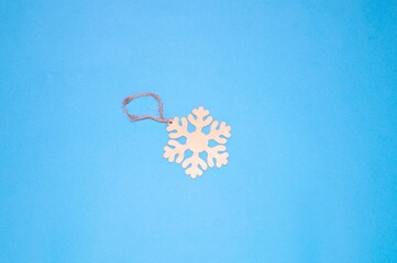 The layout of the new year, Christmas - a snowflake lies on a blue background.