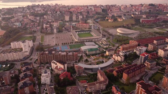Aerial of Santander Spain urban residential cityscape with el sardinero famous football stadium at sunset