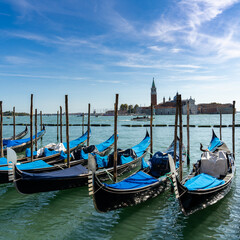 Fototapeta na wymiar moored and tied up gondolas on the canals of Venice