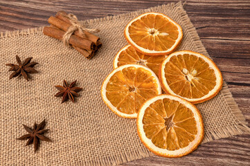 Dry orange oranges. Dried citrus fruits. Tropical fruit. On a brown background.