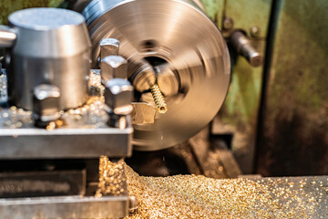 Bronze hexagon in a lathe chuck.