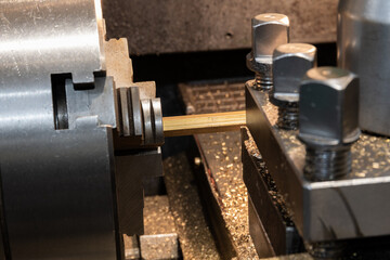 Bronze hexagon in a lathe chuck.