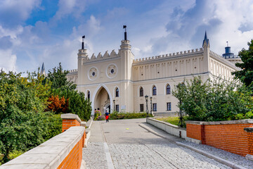 cobblestone street and bridge leading to the city gate and old town center of historic Lublin - obrazy, fototapety, plakaty