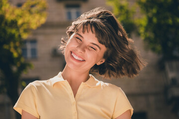 Photo of young cheerful attractive woman smile good mood fly hair blow wind enjoy outside outdoors...