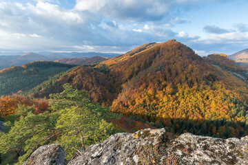 Scenic landscape in Sulov, Slovakia, on beautiful autumn sunrise with colorful leaves on trees in...