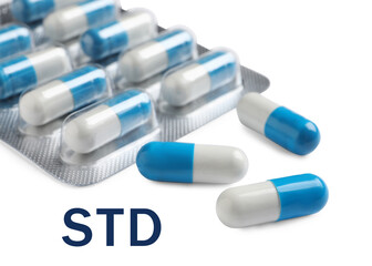 Blister with pills and abbreviation STD on white background, closeup