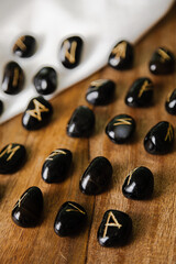 Viking ancient rune stones carved on gemstones.
Rune stone on a wooden table.
