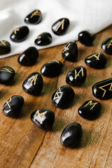 Viking ancient rune stones carved on gemstones.
Rune stone on a wooden table.
