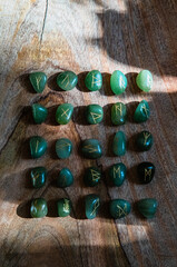 Viking ancient rune stones carved on gemstones.
Rune stone on a wooden table.