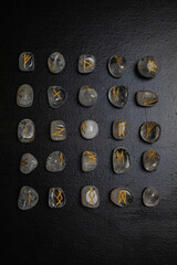 Viking ancient rune stones carved on gemstones.
Rune stone on a wooden table.