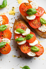 bruschetta caprese. fresh basil leaves, ripe aromatic tomatoes and Italian mozzarella on bruschetta, drizzled with olive oil and sprinkled with pepper and herbs.