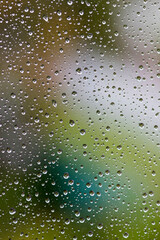 Water drops on the transparent glass of the window. Rain background, wallpaper. Macro.