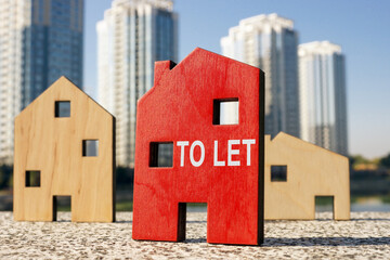 Buy to let concept. Small wooden houses.