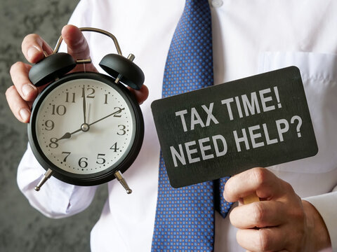 Man holds alarm clock and question Tax time, need help.