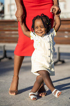 Smiling Black Girl Walking With Mother On Street