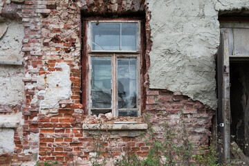 Old brick wall in an abandoned building. Doorway. Broken window