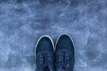 blue sneakers on a blue background top view