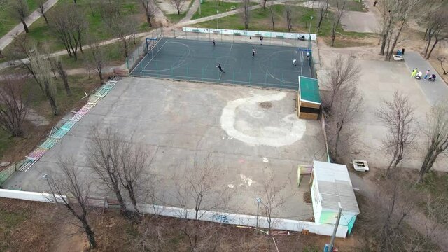 Top view of a basketball court during an outdoor game. Players on the court, on the court