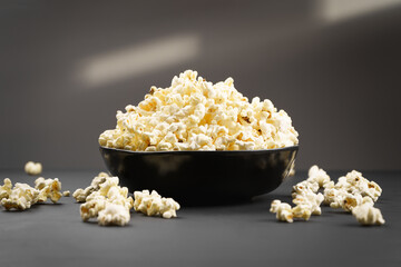 Popcorn in a bowl on a dark background.