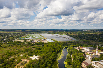 Aerial view of the Solar panels on a hill above the river in Kamianka, Ukraine