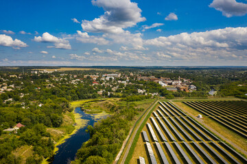 Aerial view of the Solar panels on a hill above the river in Kamianka, Ukraine