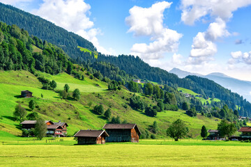Fototapeta na wymiar Landscape of valley with traditional wooden houses in Bramberg am Wildkogel