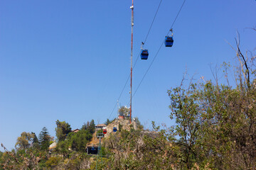 Cable cars in the sky at Cerro San Cristobal in Metropolitan Park on sunny day in Santiago de Chile
