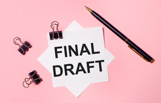 On a light pink background, black paper clips, black pen and white note paper with the words FINAL DRAFT. Flat lay