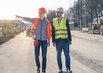 Male workers pouring of concrete pump at construction site. Real Estate Project with Civil Engineer.