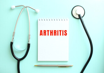 On a blue background, a stethoscope and a white notepad with the words ARTHRITIS.