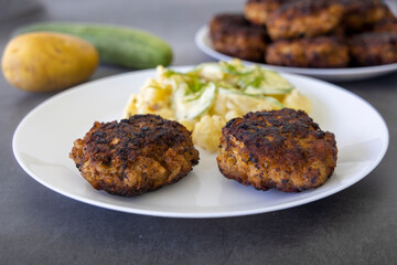 German meatballs called Frikadellen served with cucumber potato salad