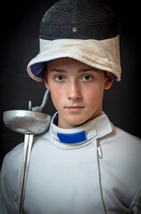 A young swordsman in ammunition and with a sword in his hand