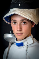 A young swordsman in ammunition and with a sword in his hand