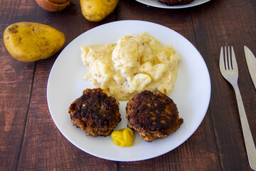 German meatballs called Frikadellen served with potato salad