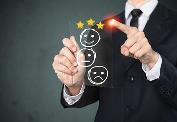 A man uses point and chooses a face smile emoticon to show on the virtual screen.