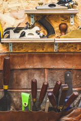 Work tools A selection of carpentry tools hang in a workshop for woodwork