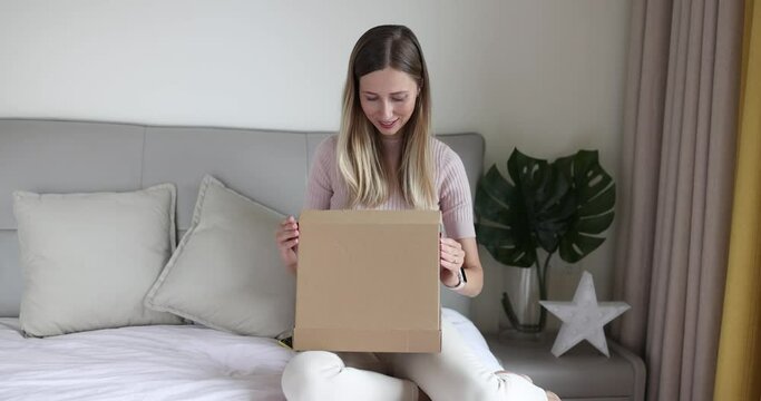Buyer unpacking box with purchased order during Black Friday sale. Business seller woman entrepreneur packing product to send consumer. Person opening carton box received parcel package from relatives