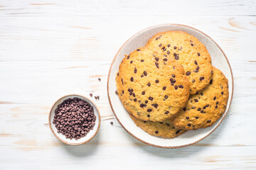 Giant cookies with chocolate chips. Trendy sweetness. Top view image at white table.