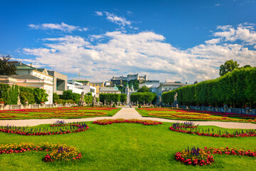 Beautiful view of famous Mirabell Gardens with the old historic Fortress Hohensalzburg in the background in Salzburg, Austria. Famous Mirabell Gardens with historic Fortress in Salzburg, Austria.