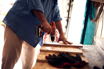 Man assembling furniture and fixing it - hobby concept.