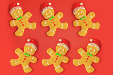 Traditional gingerbread man with icing Christmas new year cookies, flat lay pattern on red background