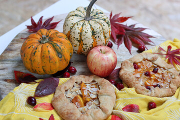Squash galettas with cinnamon and honey on wooden cutting board. Top view photo of tasty autumn dessert. 