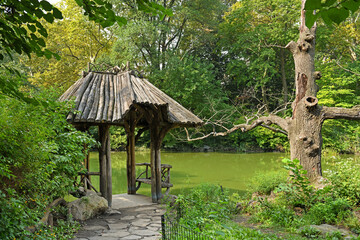 Wagner Cove, one of Central Park lesser-known treasures. This small location on edge of Lake with rustic shelter with two wooden benches. New York City