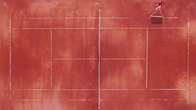 Tennis player is carrying the net along the court in a top view