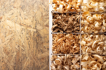 Wood shavings in box on table background. Wooden shaving at old plank board