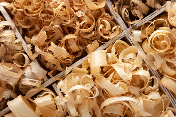 Wood shavings in box on table background. Wooden shaving from old plank board
