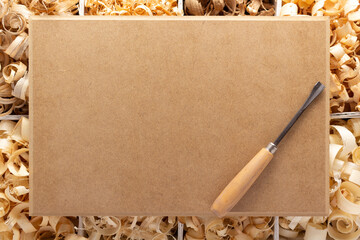 Wood shavings in box on table background. Wooden shaving at old plank board