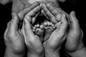 the child's legs are in the hands of the parents