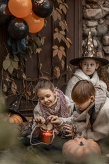 Children celebrate Halloween in outdoor decorations